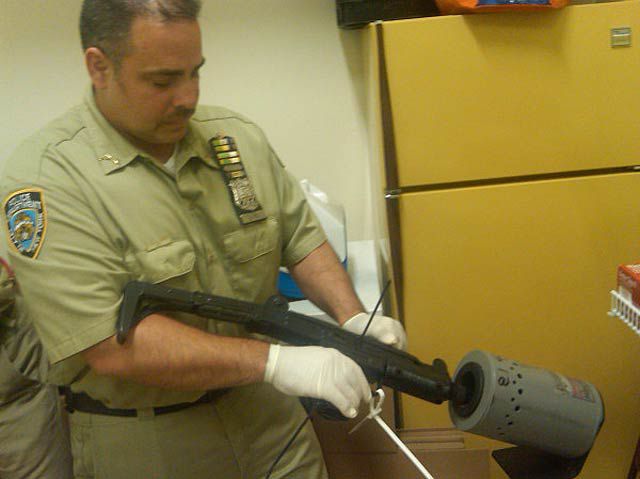 Officer Charles La Vine checks in an Uzi at the Bronx gun buyback
